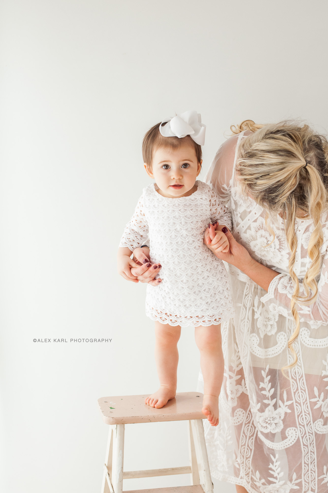 A baby stands with her mother | Alex Karl Photography | Palm Beach Family Photographer