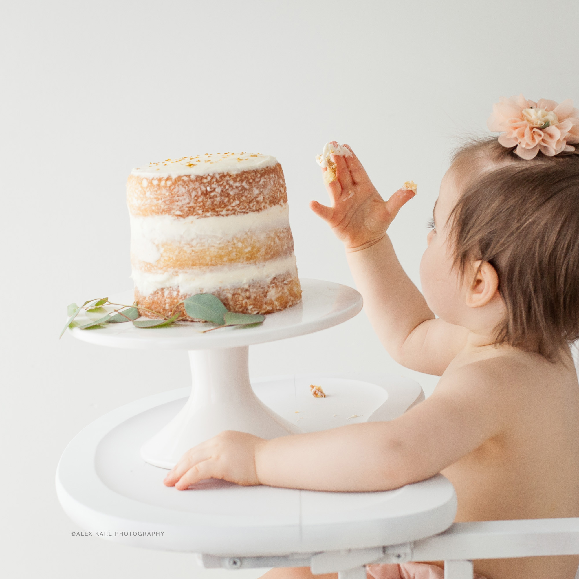 A baby eats her birthday cake | Alex Karl Photography | Palm Beach Family Photographer