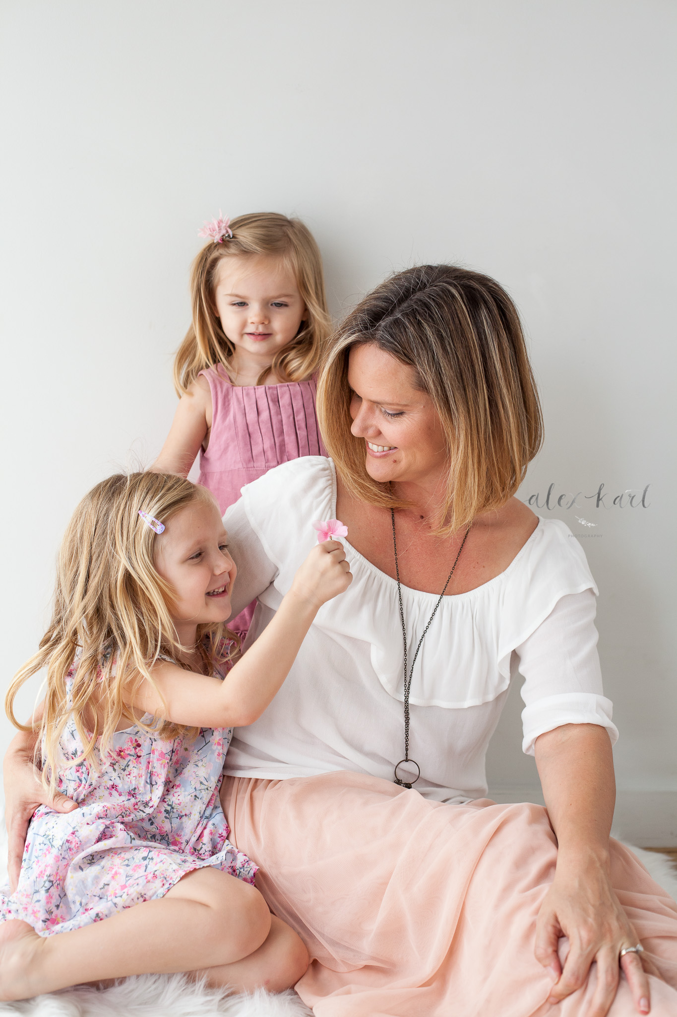 A girl gives her mom a flower  | Alex Karl Photography | Palm Beach Family Photographer