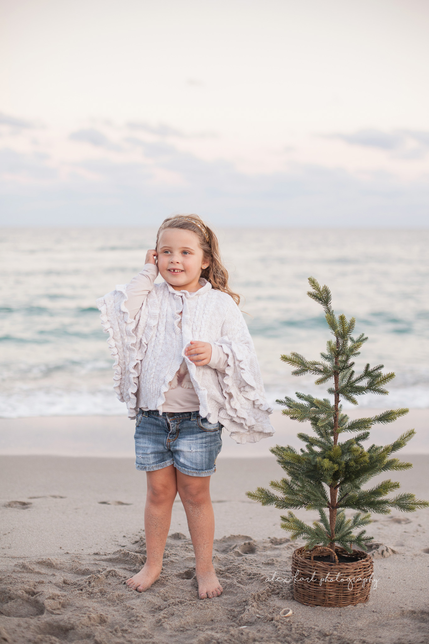 A girl stands by a tree in front of the shore | Alex Karl Photography | Palm Beach Family Photographer