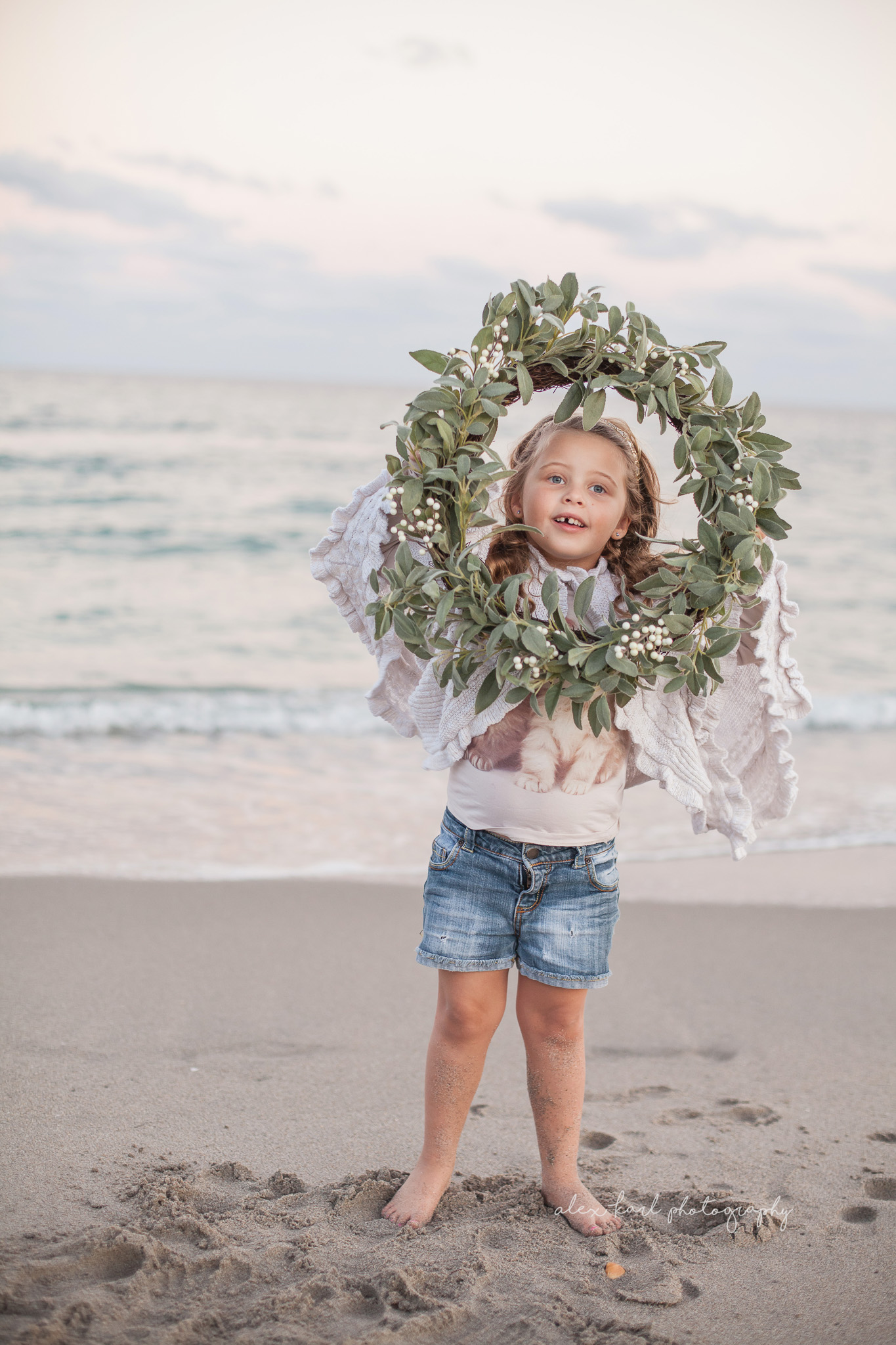 A girl holds a wreath | Alex Karl Photography | Palm Beach Family Photographer