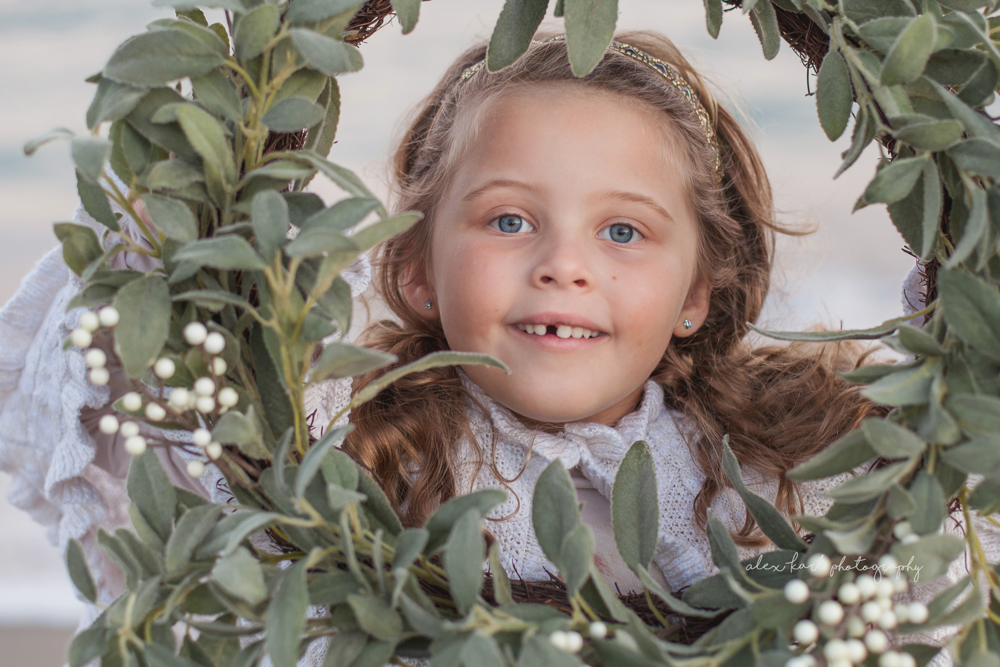 A child peeks through a wreath | Alex Karl Photography | Palm Beach Family Photographer