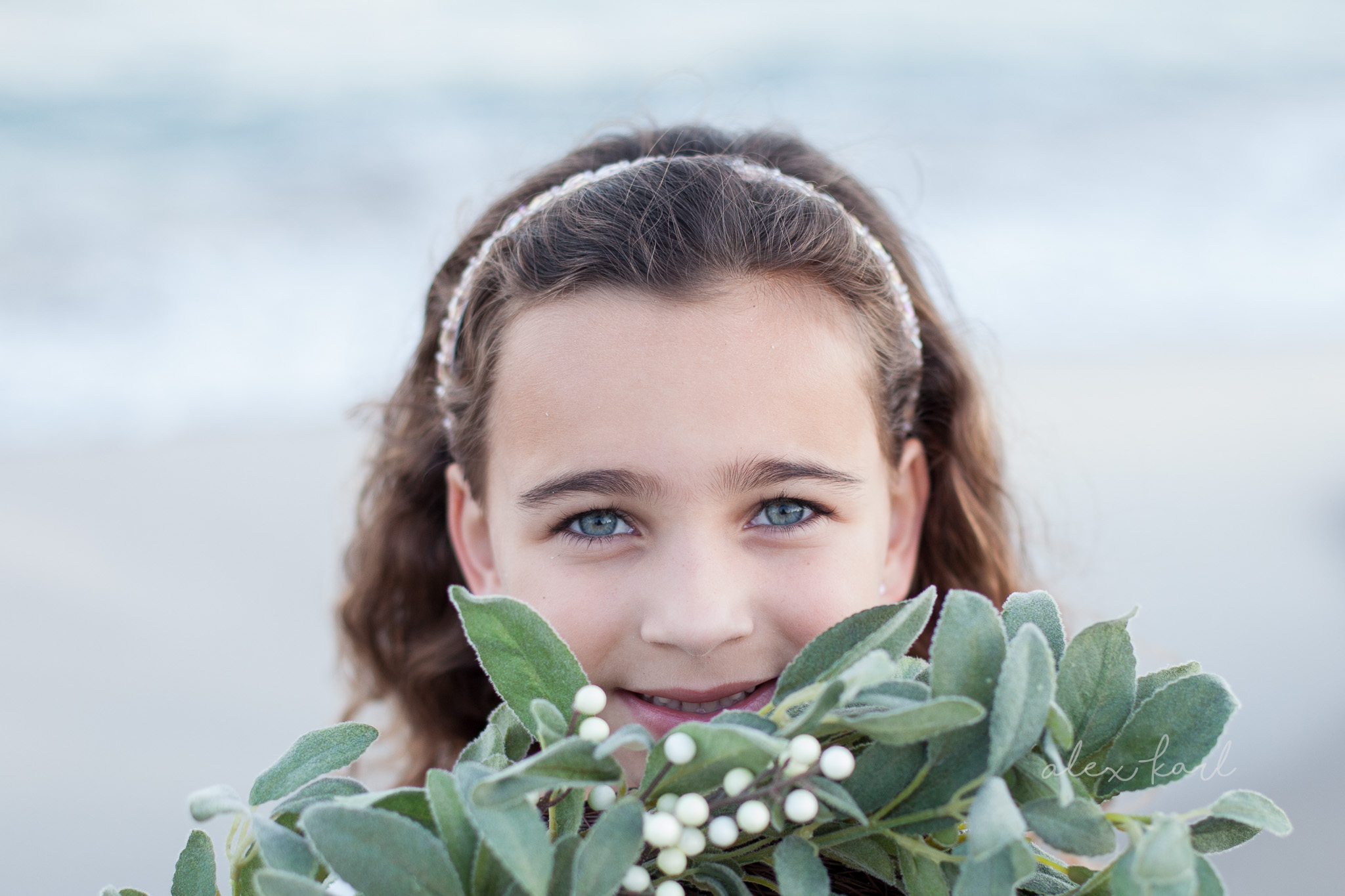 A girl holds a wreath close | Alex Karl Photography | Palm Beach Family Photographer