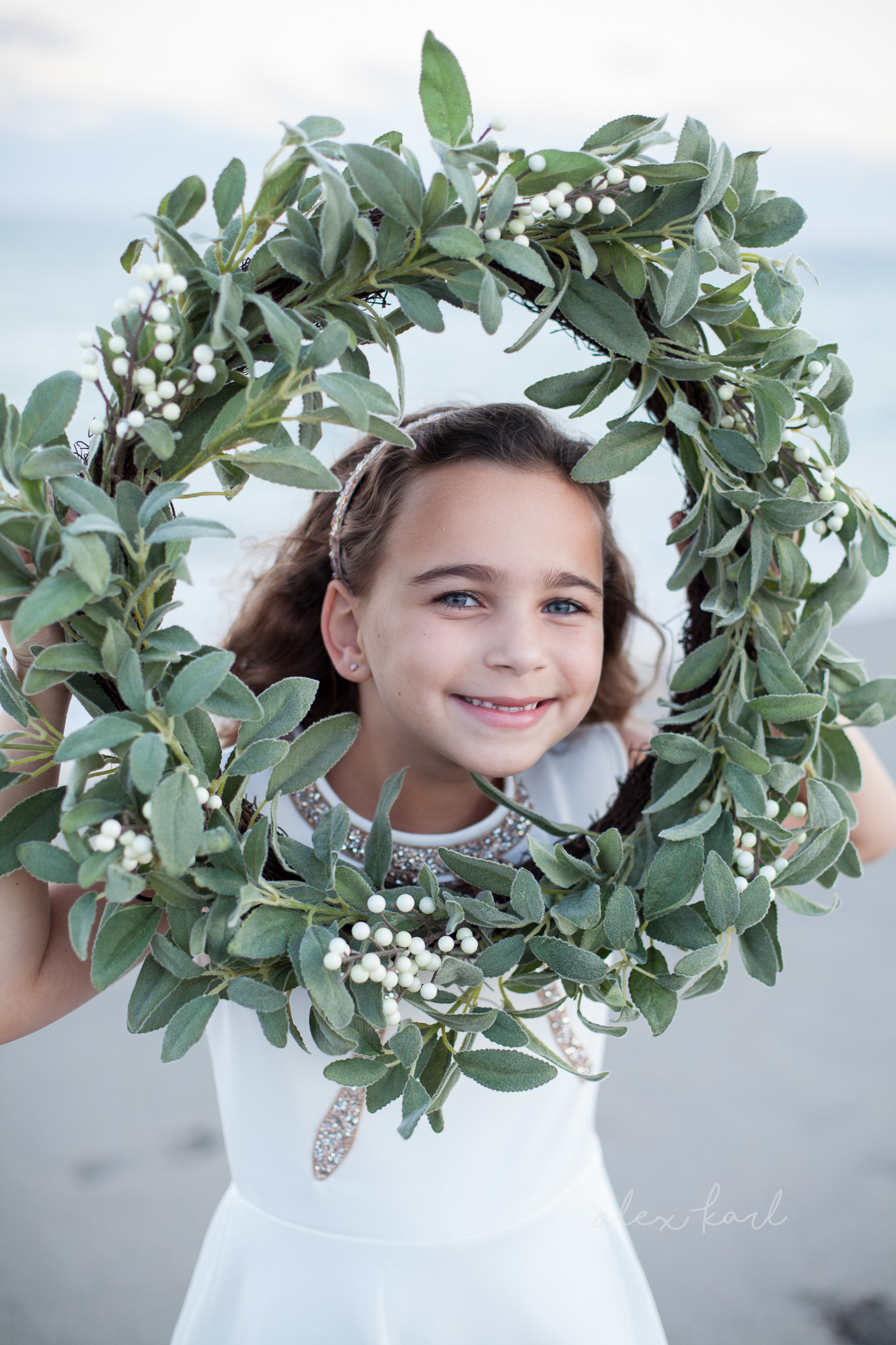 A wreath frames a little girl's face | Alex Karl Photography | Palm Beach Family Photographer