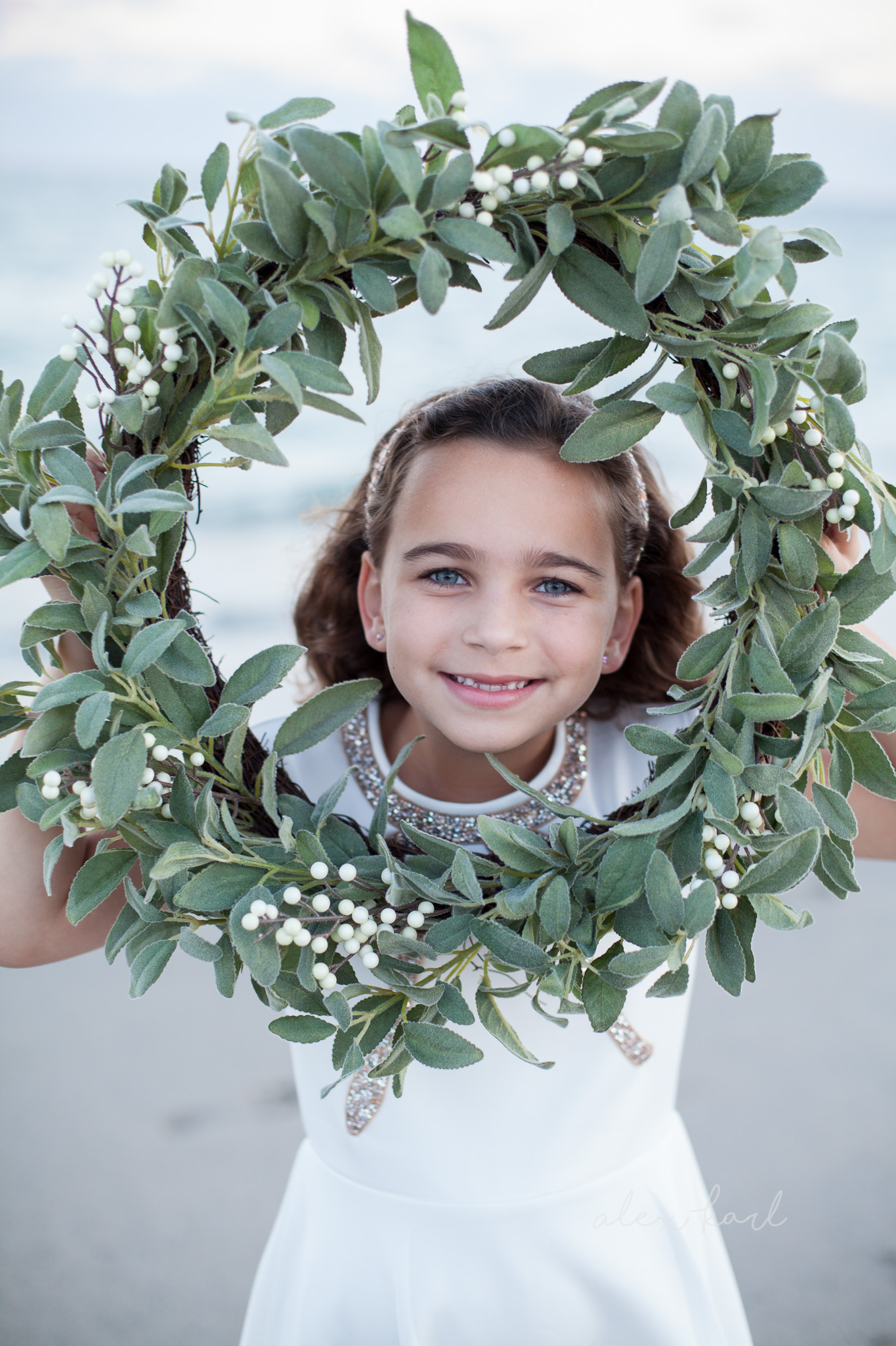 A wreath frames a child's face | Alex Karl Photography | Palm Beach Family Photographer