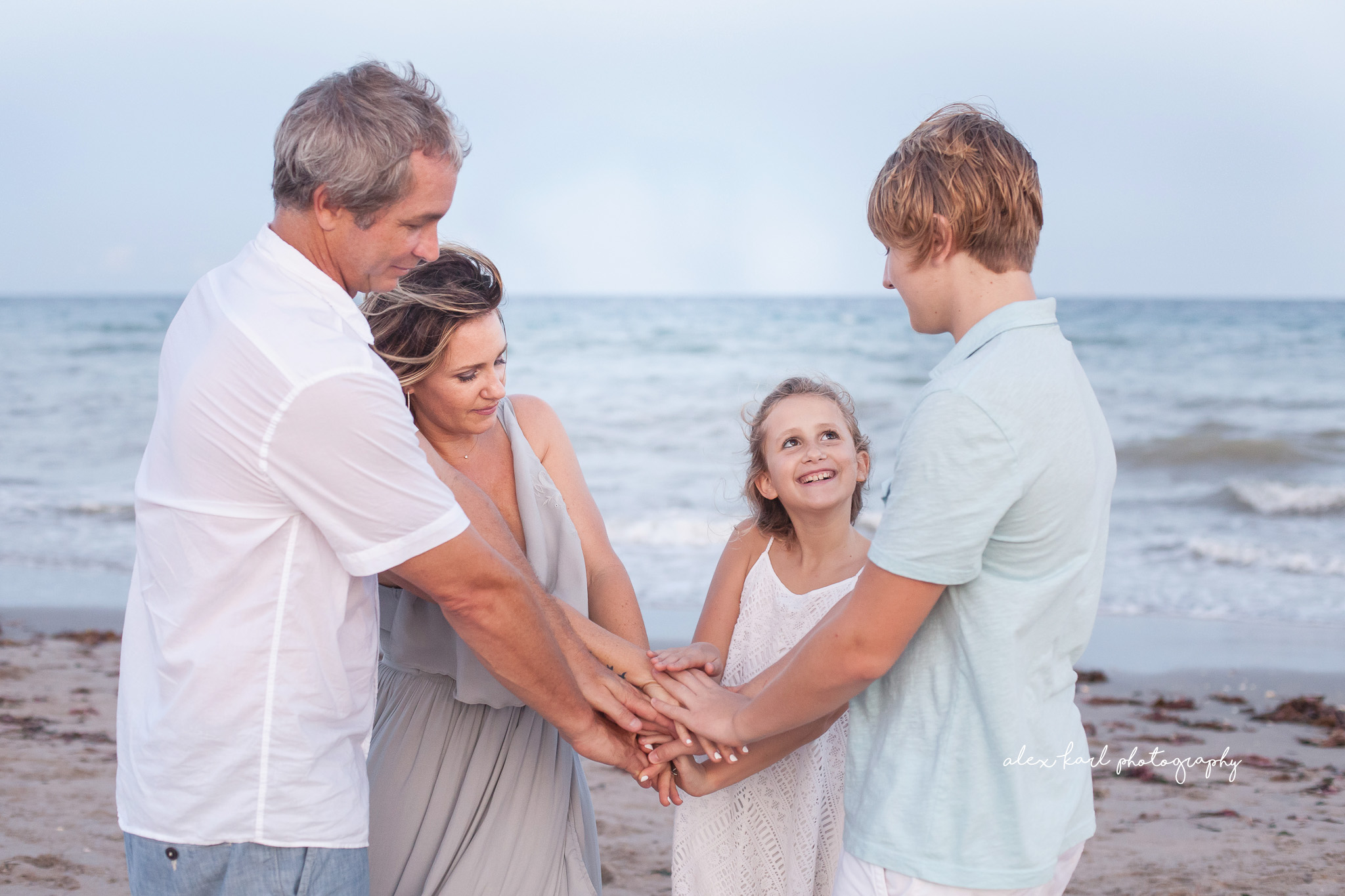 A family holds hands  | Alex Karl Photography | Palm Beach Family Photographer